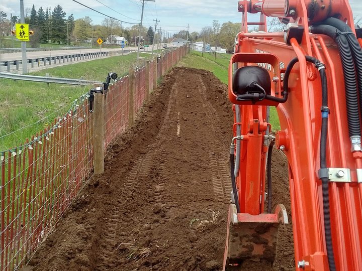 Trenching alongside an existing roadway