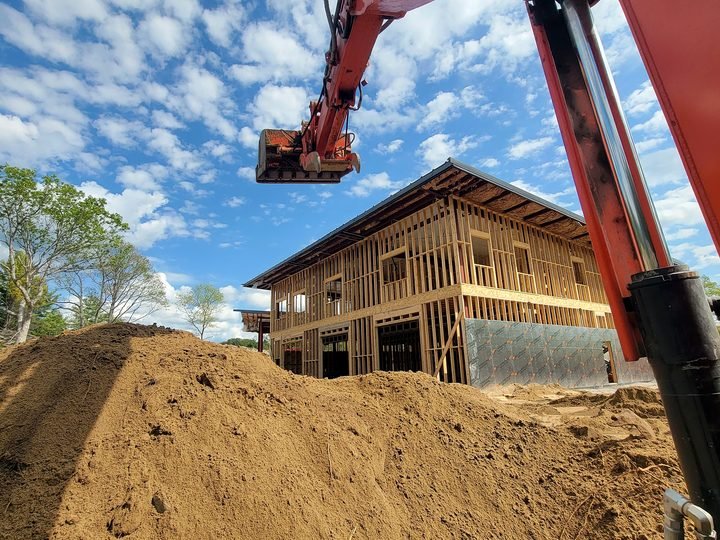 Excavation work alongside a building under construction in Simcoe County
